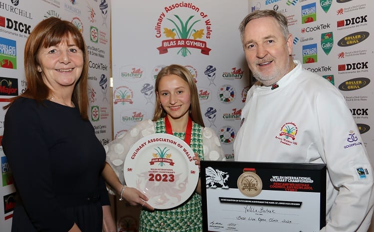 Yuliia Batrak receives her award from Lesley Griffiths, Minister for Rural Affairs and North Wales and Arwyn Watkins, OBE, Culinary Association of Wales president