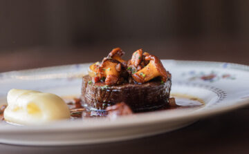 Chargrilled fillet of beef, ratte potato purée, pancetta, silverskin onion, chanterelles & oxtail jus.